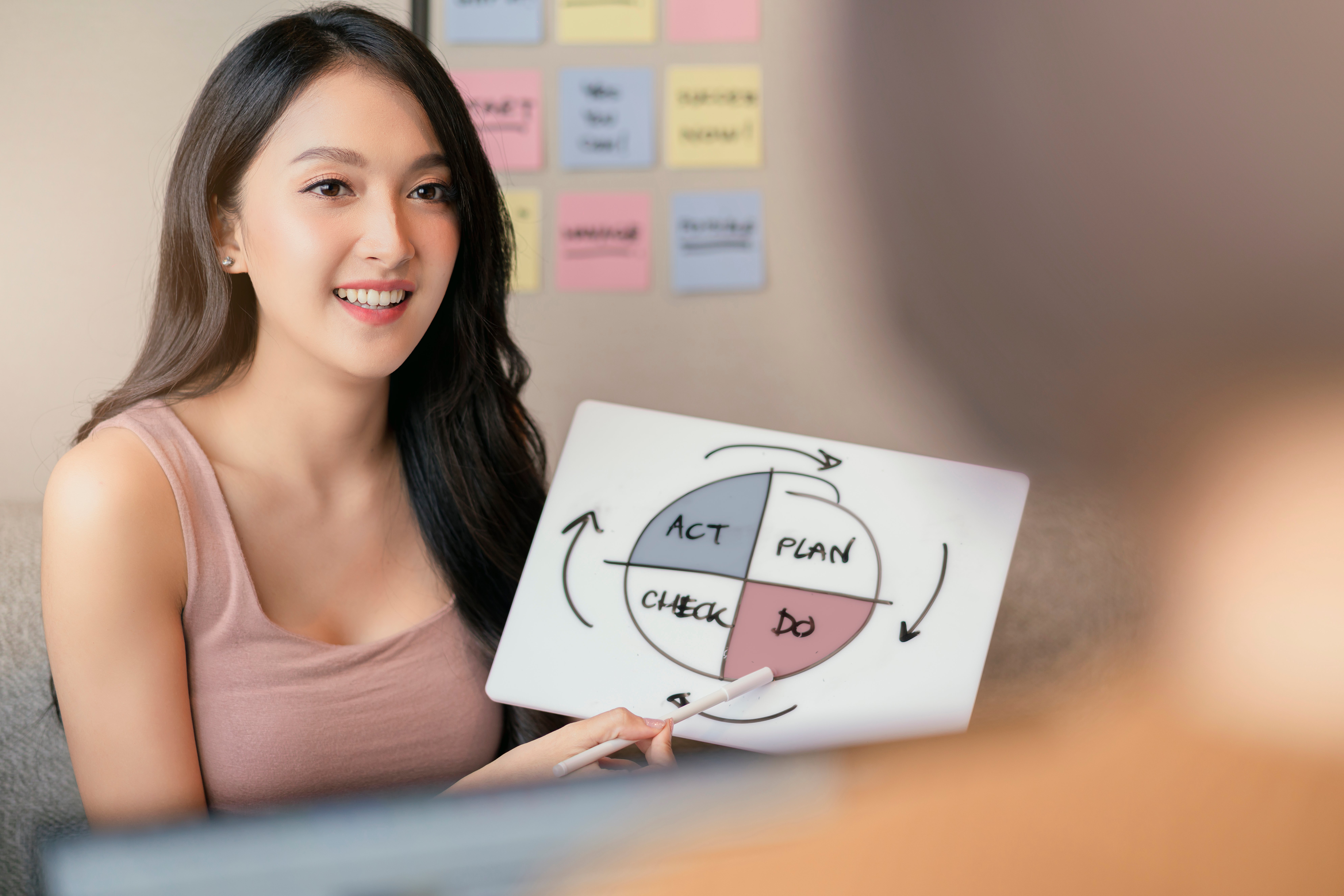 young-attractive-asian-female-entrepreneur-hand-present-discussion-explain-business-plan-strategy-diagram-chart-co-worker-colleague-team-casual-meeting